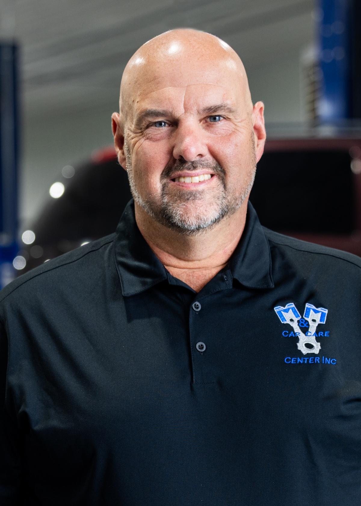 Auto repair shop owner in a shop-branded shirt