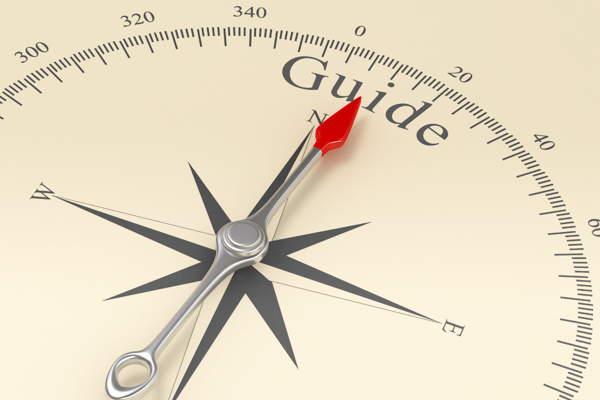 Compass needle pointing toward the word guide