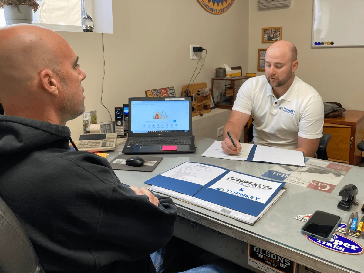 Auto repair team member helping a customer at the service counter