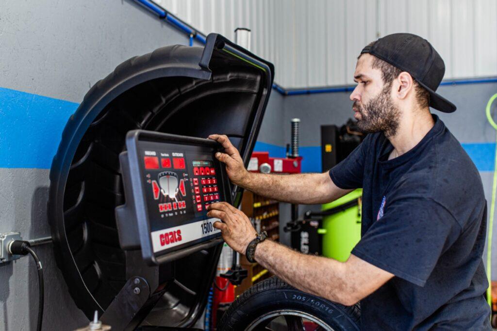 Technician working on a tire in at M&M Car Care Center - Turnkey Marketing 